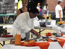 Chef preparing a meal at Taste of Olean / Art in the Park